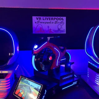 Guest riding the branded VR Moto simulator
